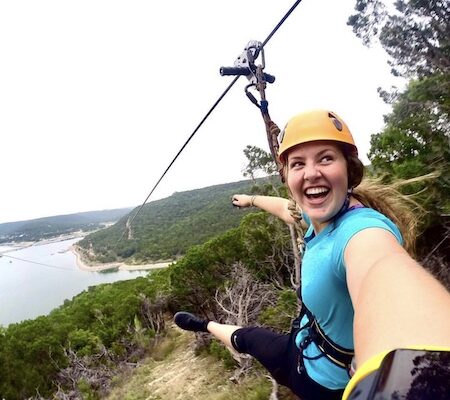 Smiling girl down Zipline