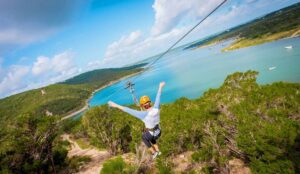 Person Soaring over Lake Travis mid flight with their arms out stretched