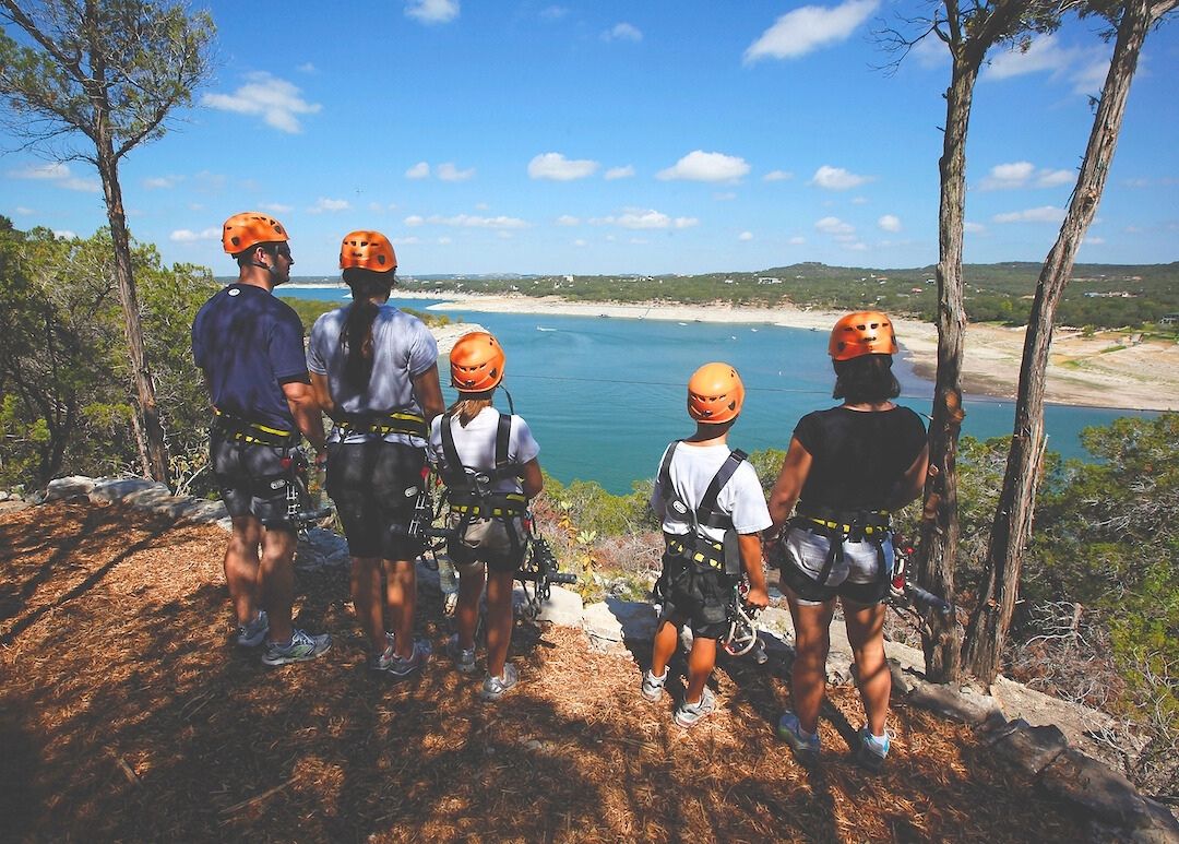 Family of 4 enjoying the lake view during their trip