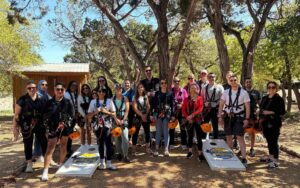 Corporate/ work event posing in front of corn hole game area
