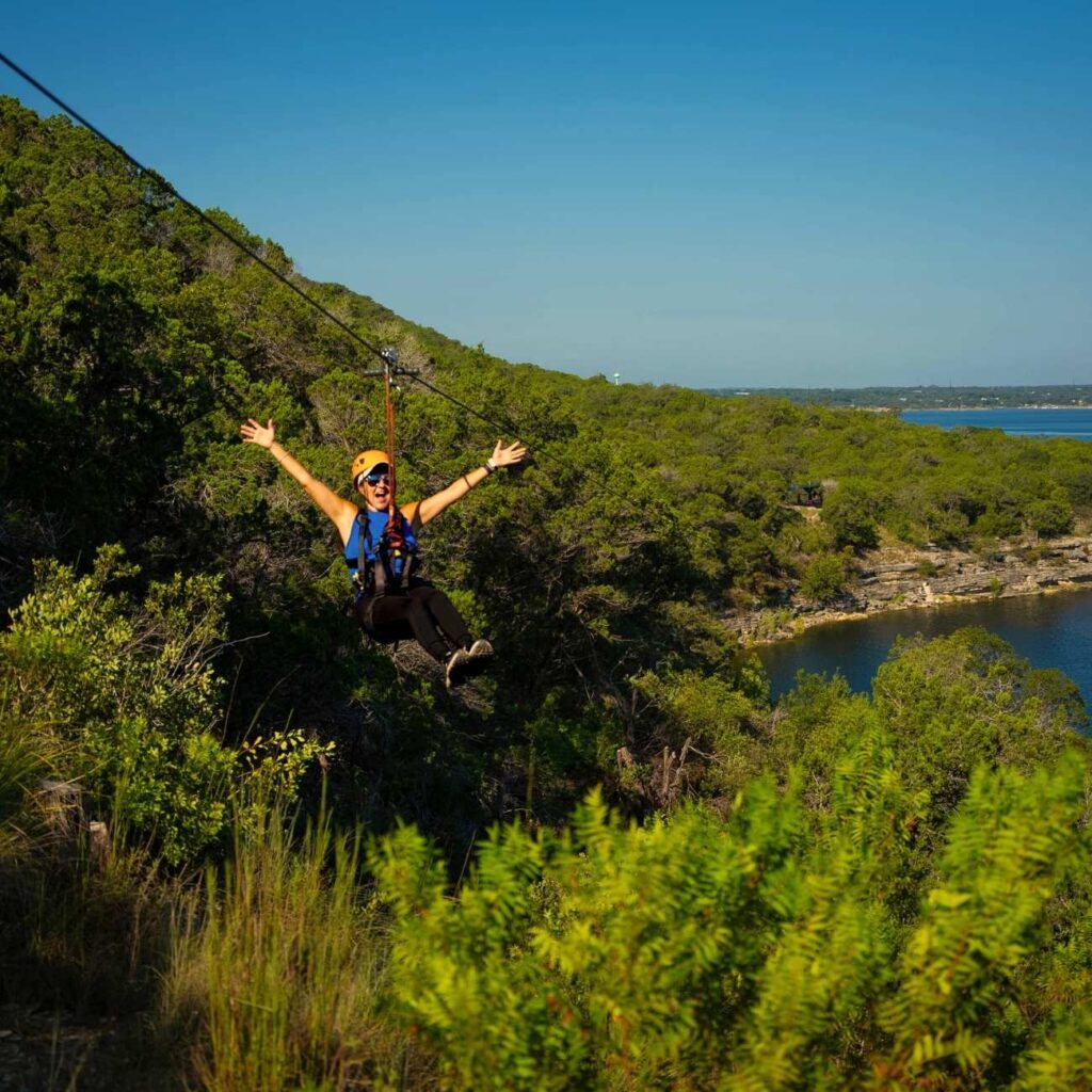 Zip liner headed down 1,600 feet of zipline with her arms wide open.