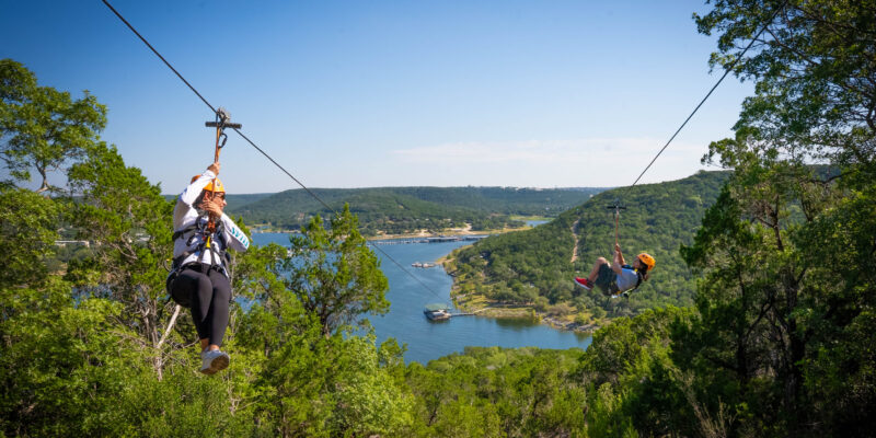 2 people Zipping down the Final Zipline of the tour